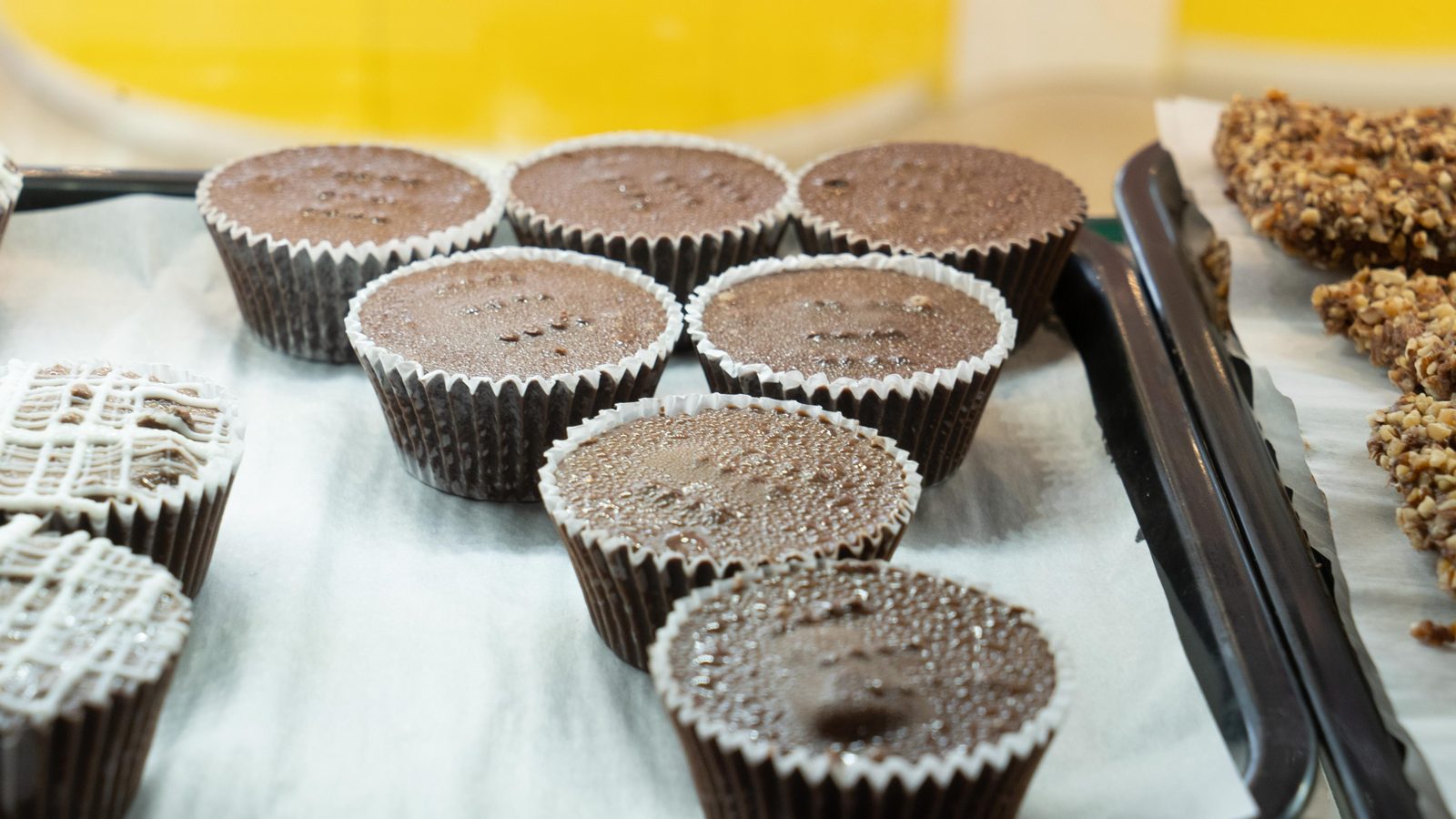 Jumbo chocolate cups and haystacks in the sweets case